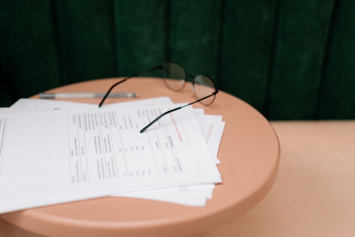 Papers and reading glasses on a round table