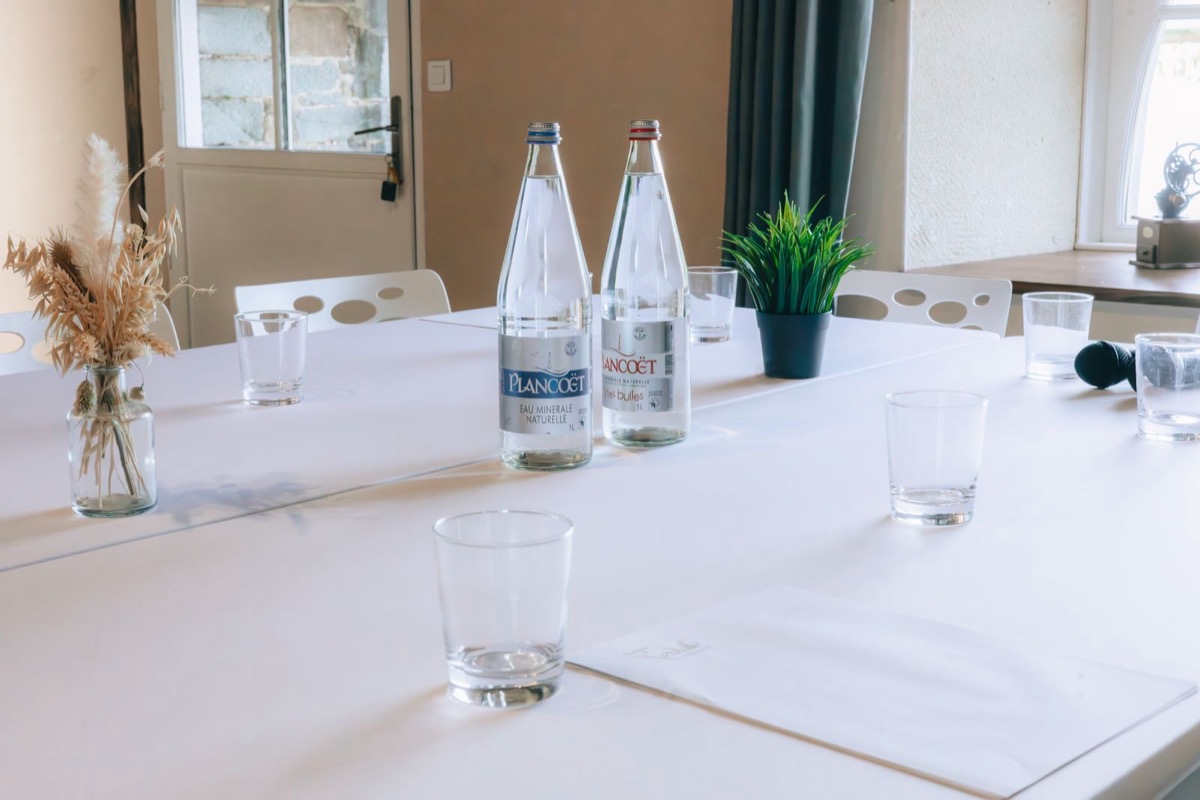 A meeting table set with glasses and water