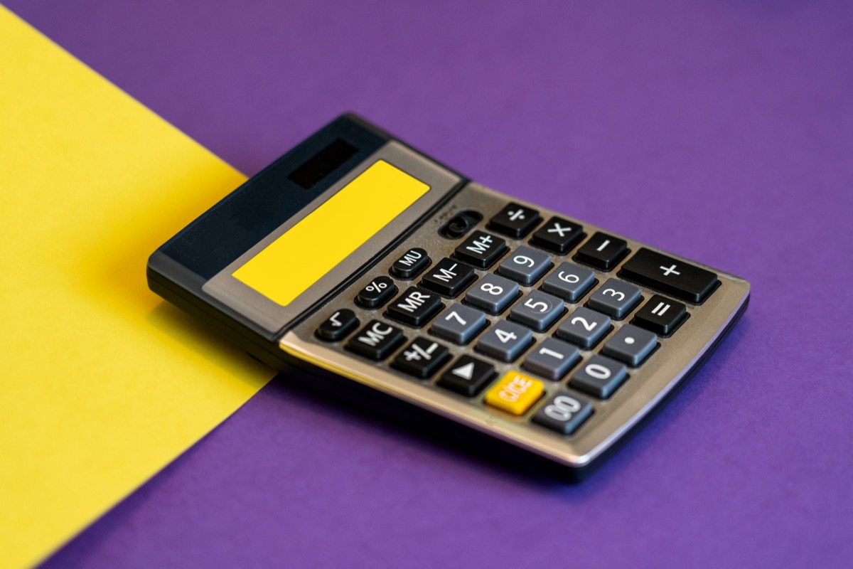 A calculator on a yellow and purple background