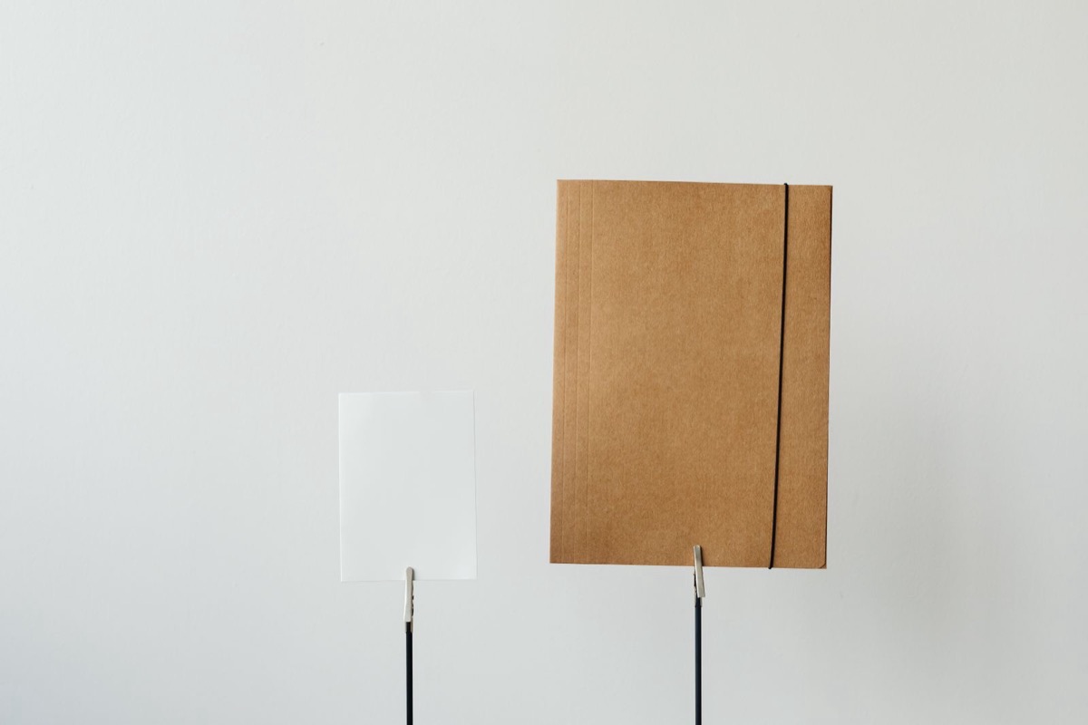A brown folder standing on a white desk