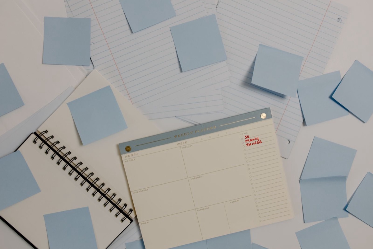 A planner and sticky notes on a desk