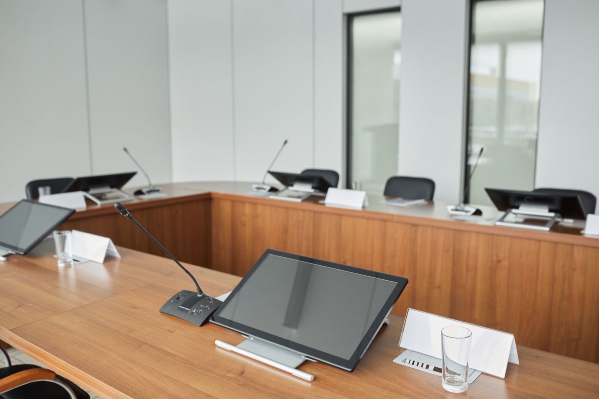 A conference room with a long wooden table